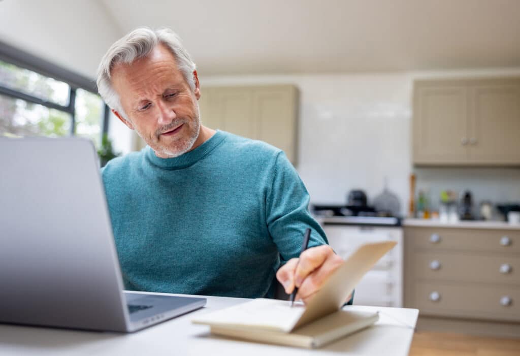 Peer to Peer Lending in NZ - A Guide for Investors 2 A mature man sits at his kitchen table as he works.