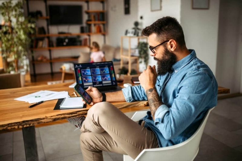Investor trading at home using his laptop