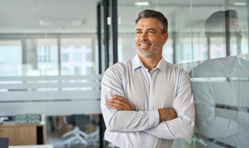 The Type of Loans Your Investment Can Support 2 Businessman standing in office arms crossed looking away