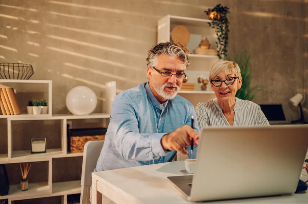 Senior couple looking at their investment portfolio and KiwiSaver.