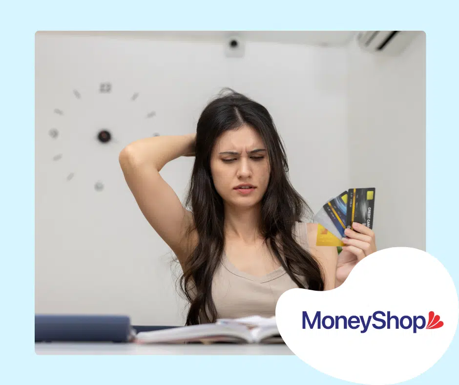 Person holding credit cards, studying unsecured personal loans nz.
