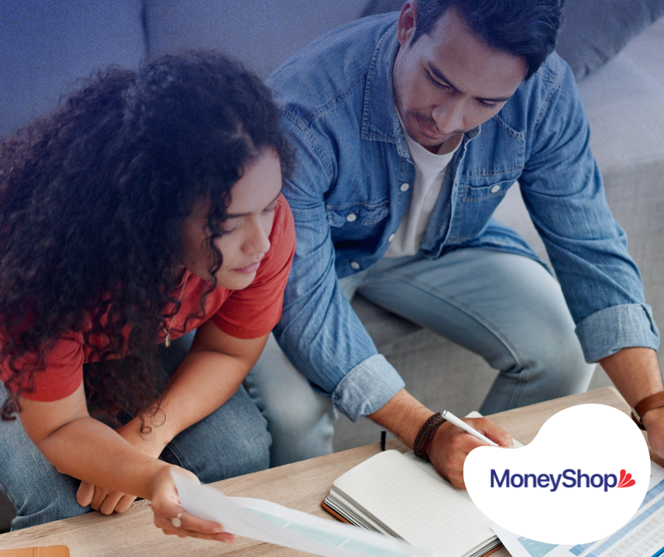 Couple discussing finances and notes.